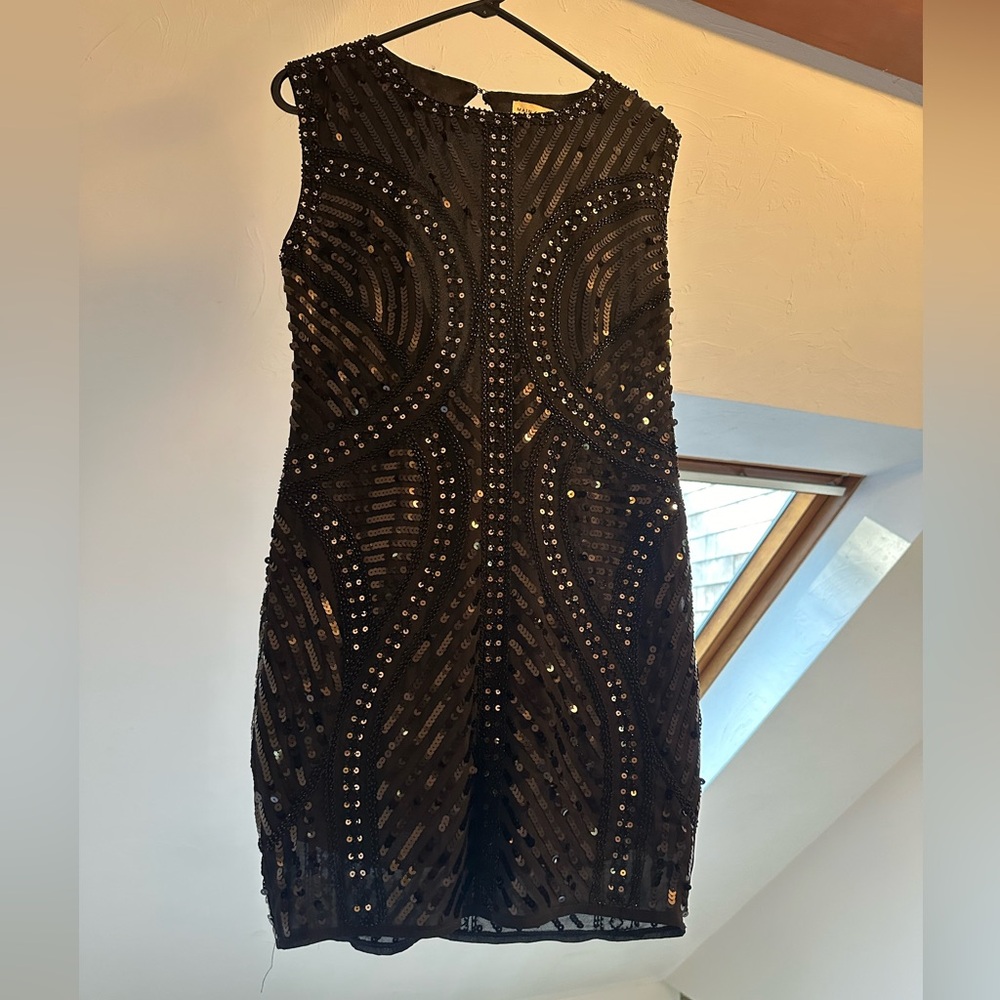 Black sequined mini dress with back cutout detailing.